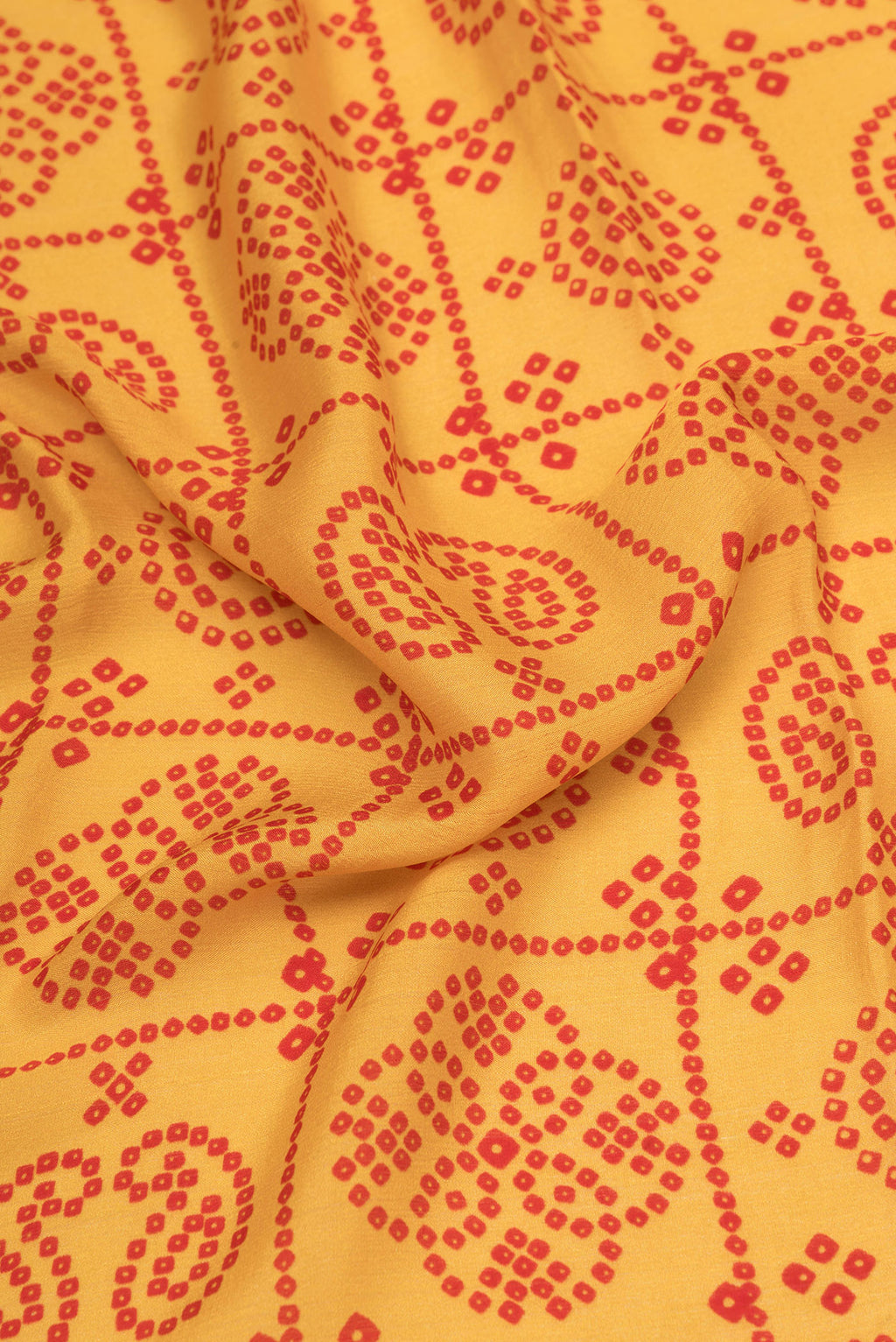 Close up of Mustard Mysore Chiffon Saree with Printed design on the body and Zari Border.  displaying folds