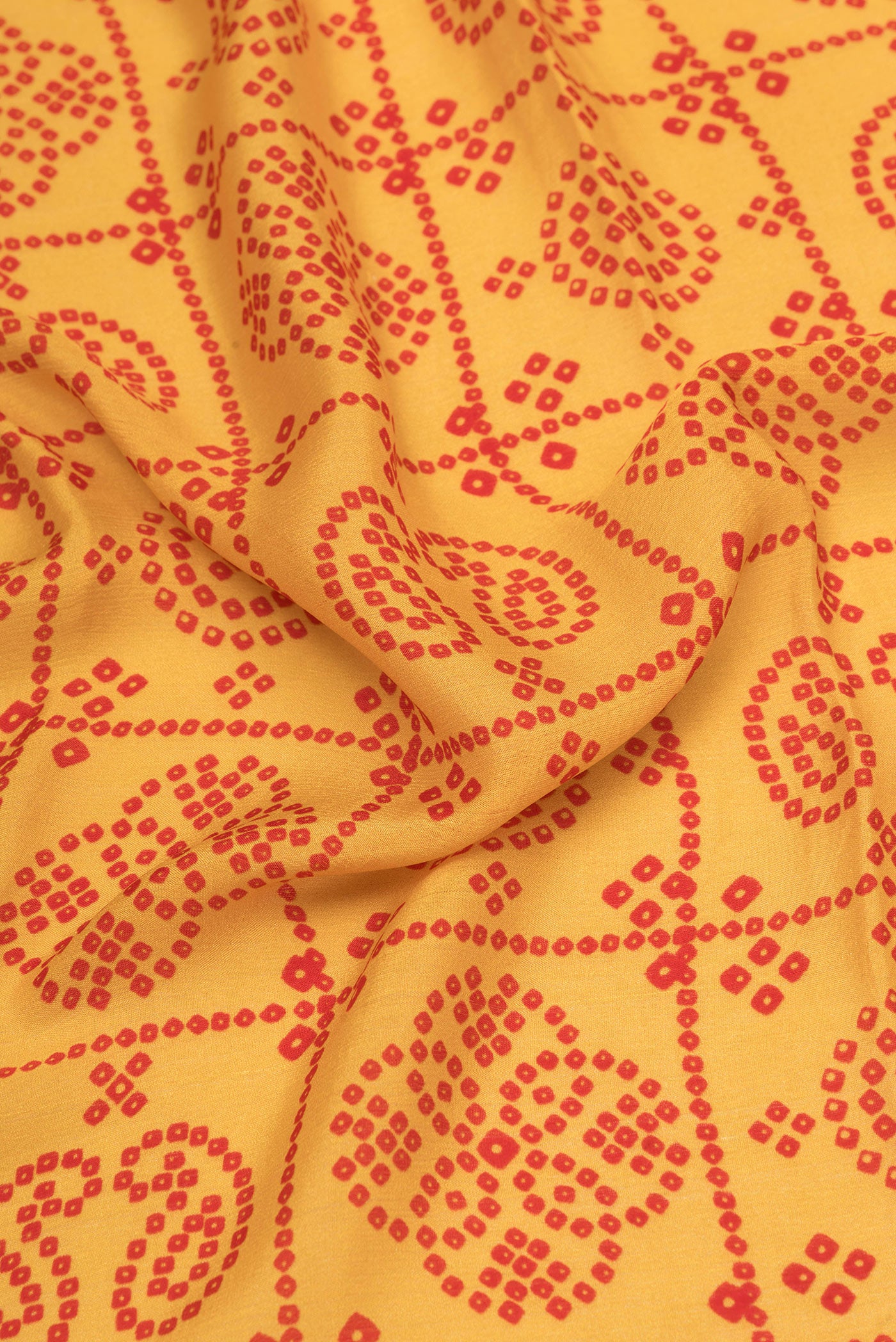 Close up of Mustard Mysore Chiffon Saree with Printed design on the body and Zari Border.  displaying folds