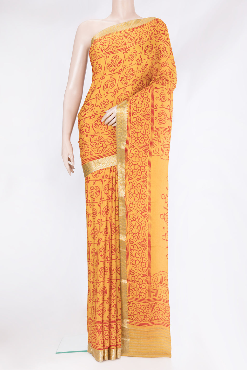 Mustard Mysore Chiffon Saree with Printed design on the body and Zari Border.  displayed on a mannequin