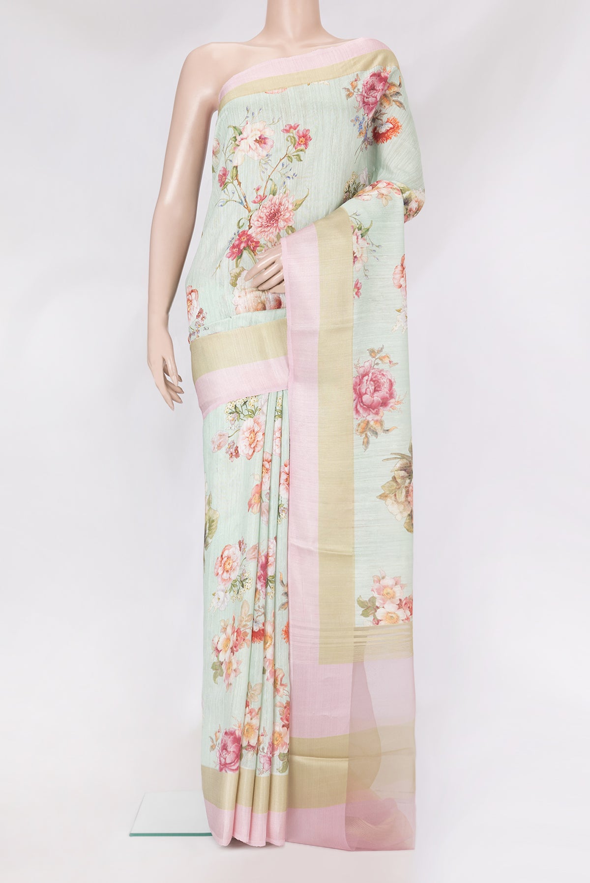 Sea Green Tussar Silk Saree with Floral Print on the body and Printed Border.  displayed on a mannequin