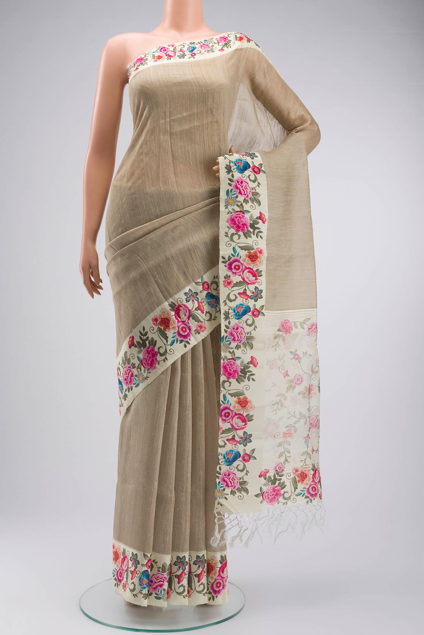 Beige Tussar Silk Saree with Plain Body and Printed Border displayed on a mannequin