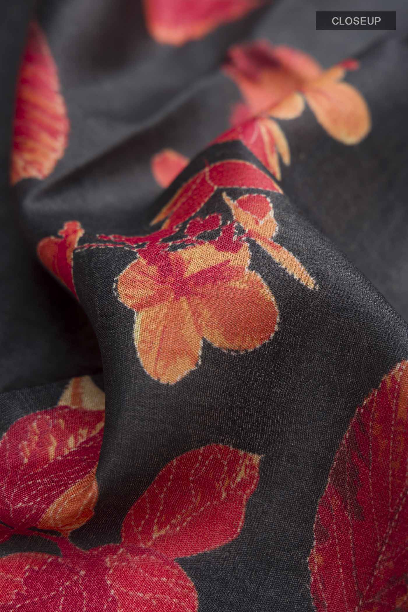 Close up of Black Bhagalpuri Tussar Silk Saree with Floral Print on the body and Zari Border displaying folds