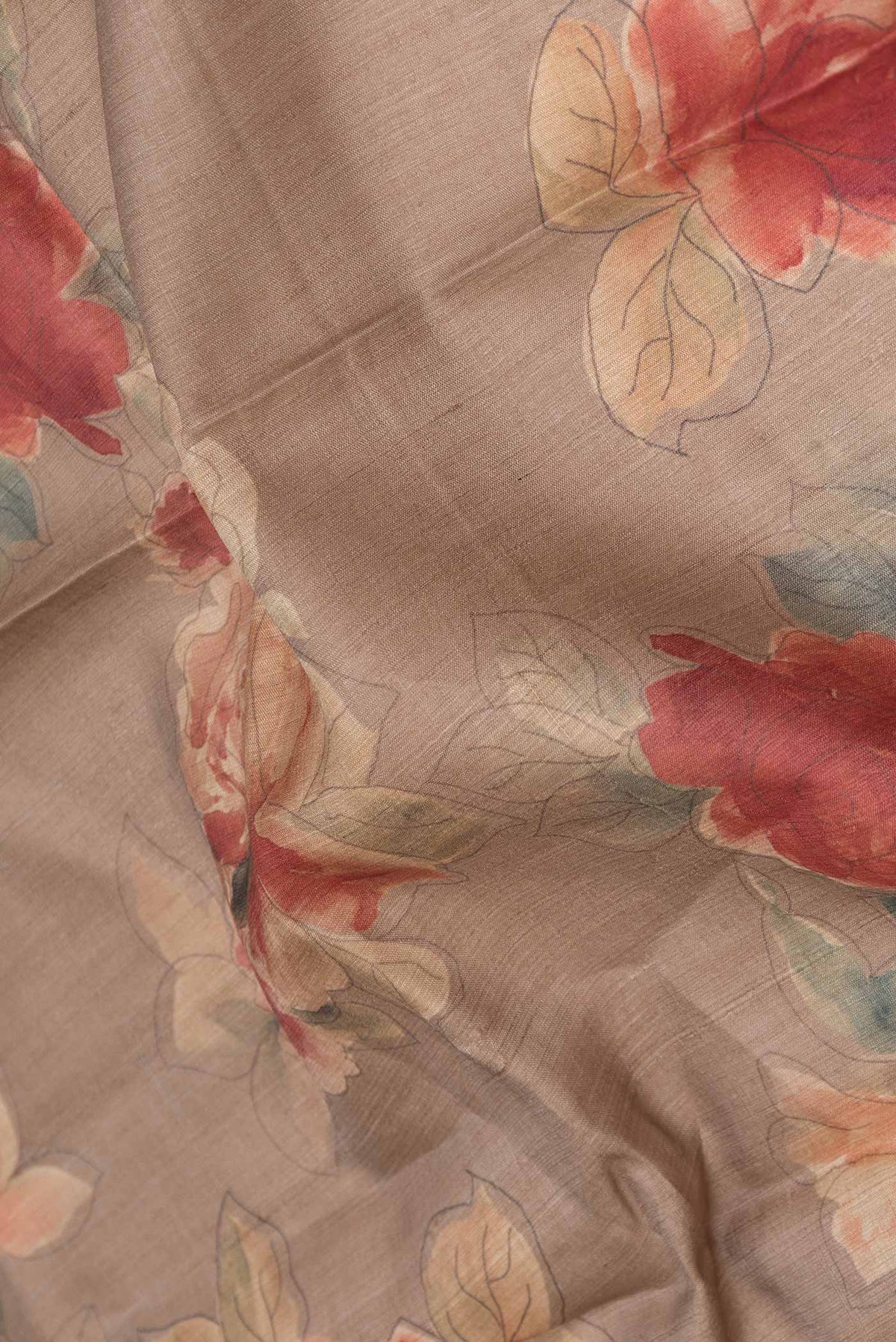 Close up of Beige Dual Tone Tussar Silk Saree with Printed design on the body and Zari Border displaying folds
