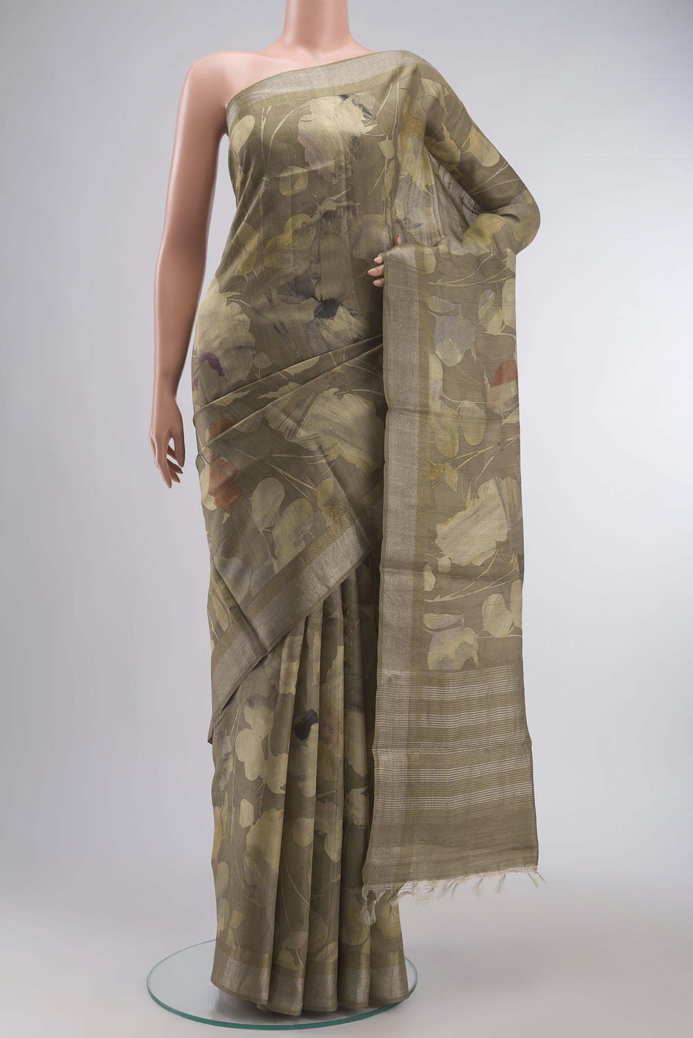 Beige Tussar Silk Saree with Printed design on the body and Zari Border displayed on a mannequin