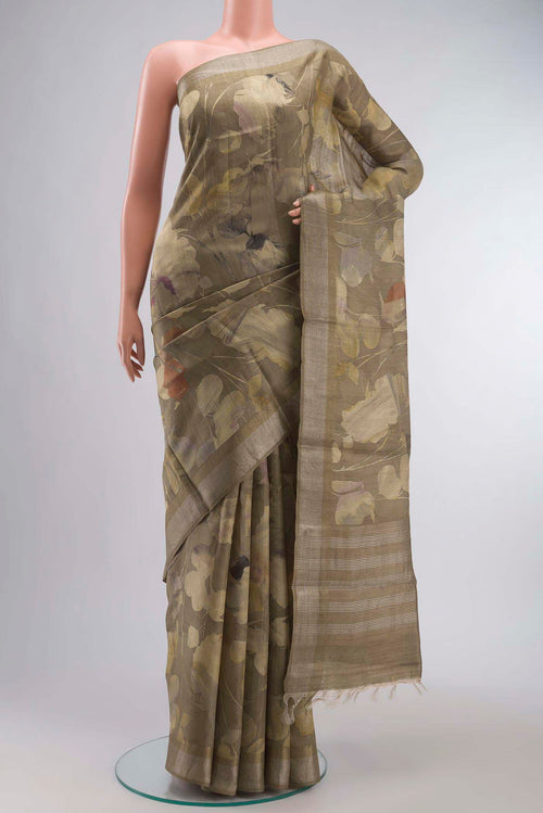 Beige Tussar Silk Saree with Printed design on the body and Zari Border displayed on a mannequin