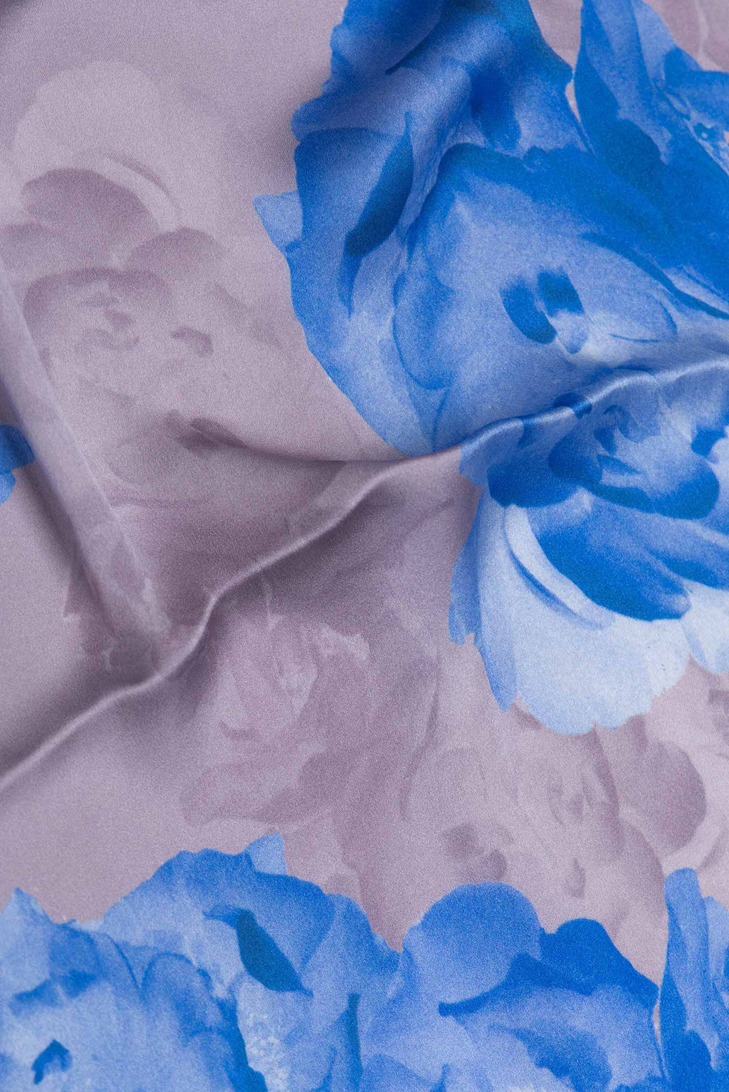 Close up of Brown Dual Tone Mysore Crepe Saree with Printed design on the body and Without Border displaying folds