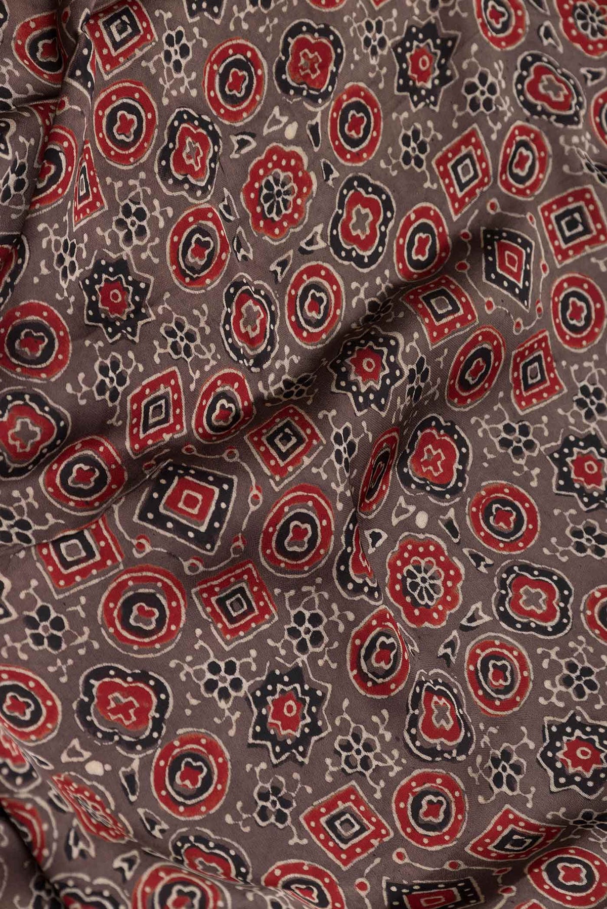 Close up of Brown Dual Tone Linen Saree with Printed design on the body and Zari Border displaying folds