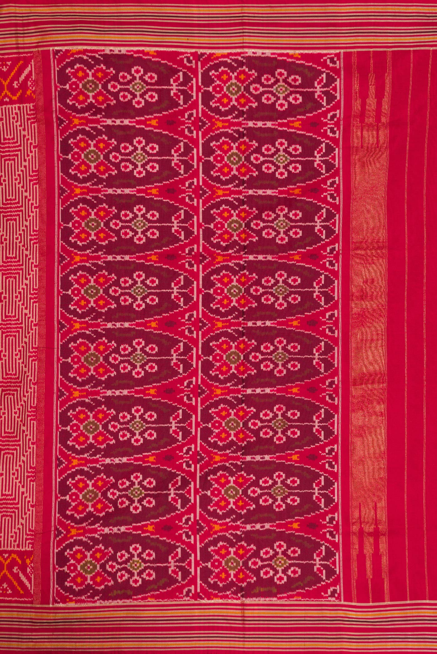 Close up image of the pallu of Maroon Dual Tone Double Ikat Saree with Ikat Print on the body and Thread Border. 