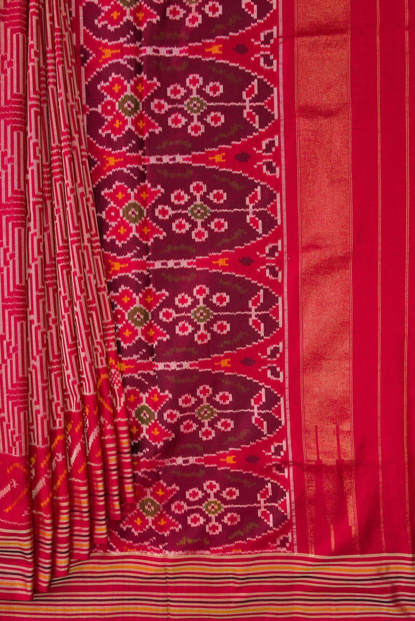 Pleats and pallu of Maroon Dual Tone Double Ikat Saree with Ikat Print on the body and Thread Border. 