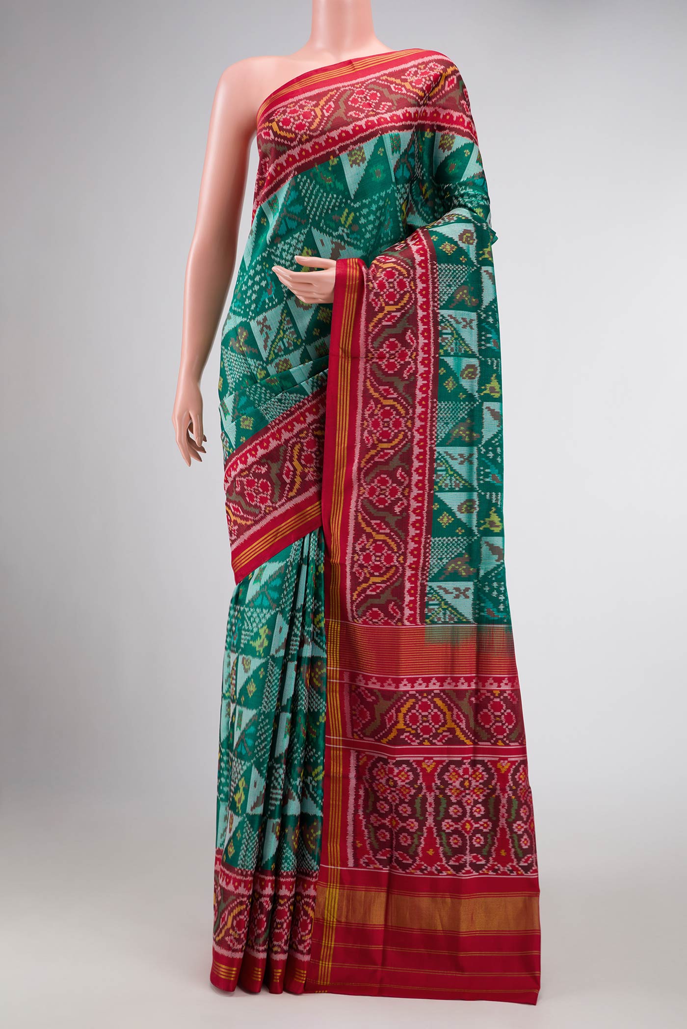 Green Dual Tone Rajkot Patola Silk Saree with Ikat Print on the body and Ikat Border displayed on a mannequin