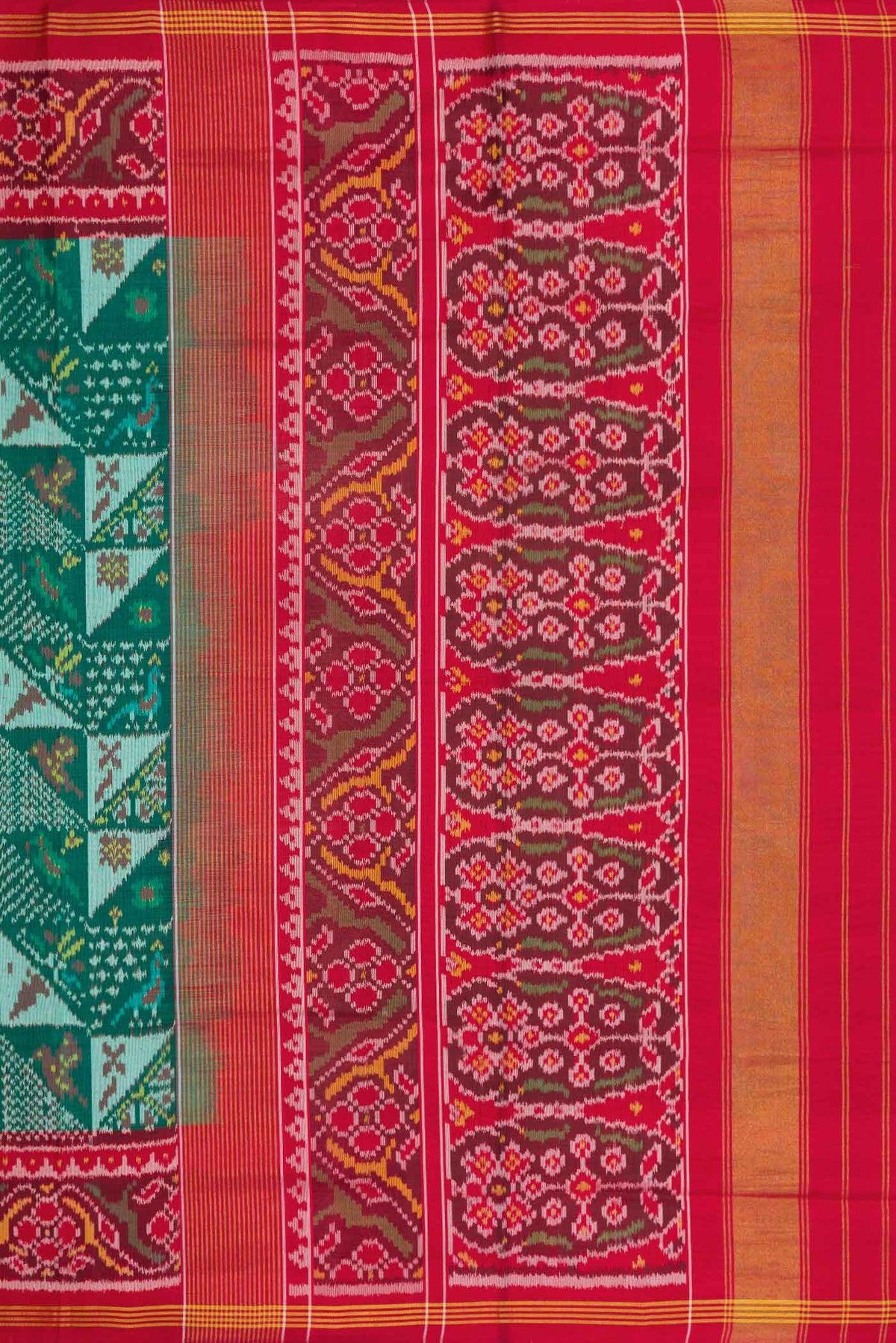 Close up image of the pallu of Green Dual Tone Rajkot Patola Silk Saree with Ikat Print on the body and Ikat Border