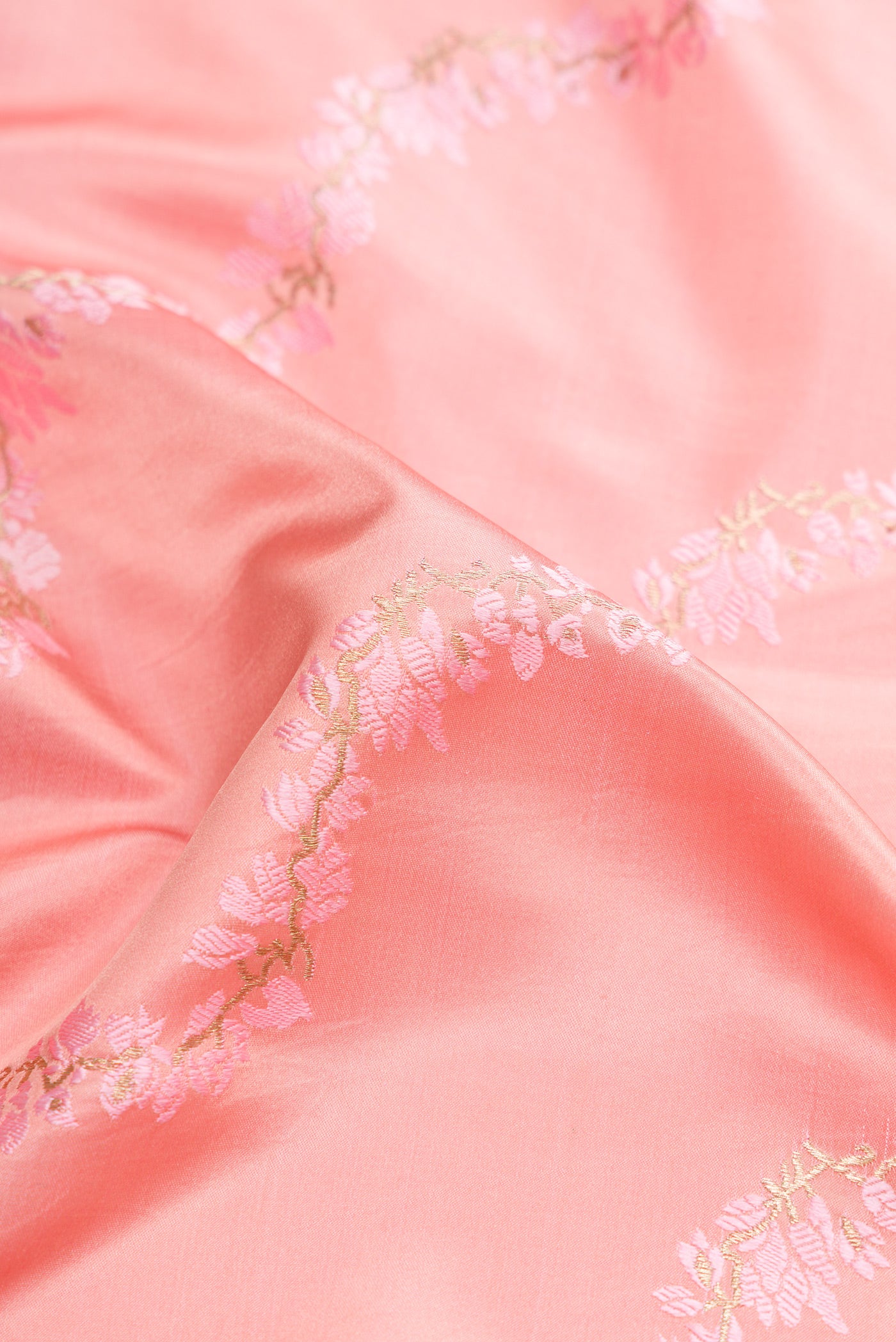 Close up of Pure Silk Pure Zari Pink Dual Tone Banarasi Saree with Embroidery on the body and Embroidery Border.  displaying folds