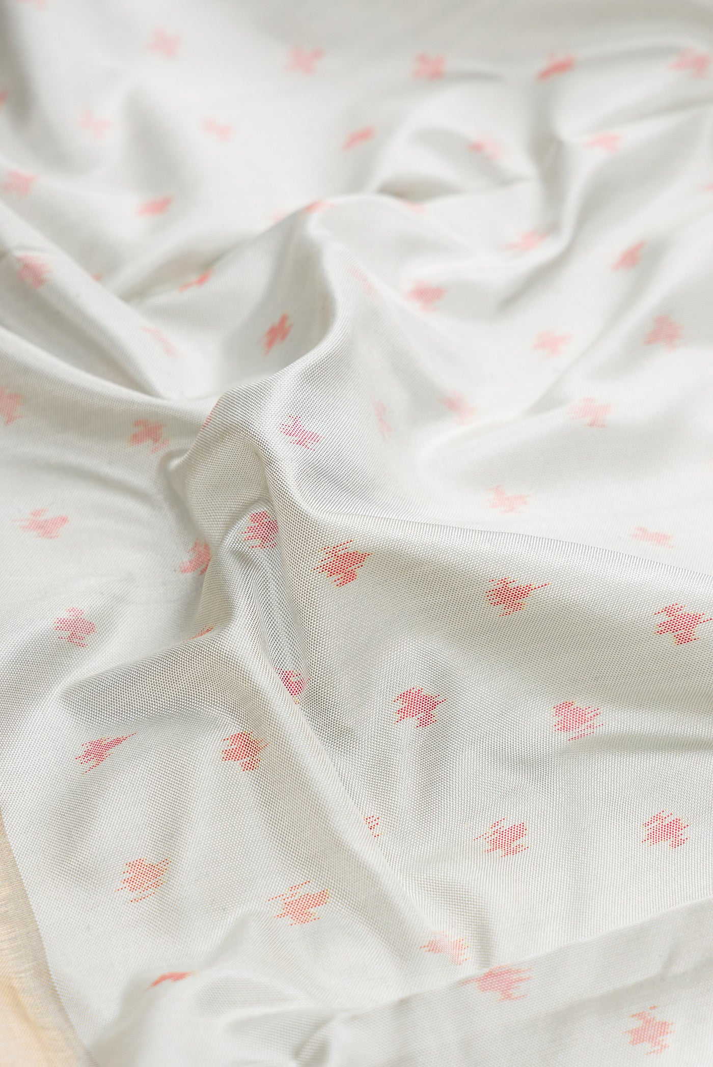 Close up of Grey Dual Tone Kanjivaram Silk Saree with Ikat Print on the body and Ikat Border.  displaying folds