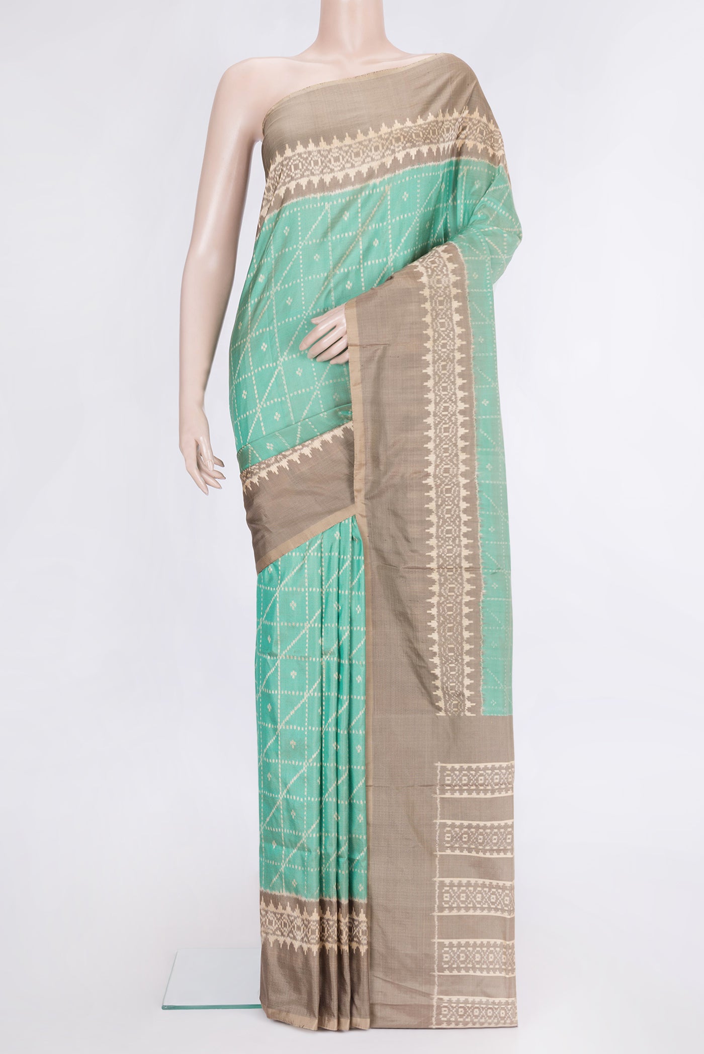 Sea Green Dual Tone Double Ikat Saree with Ikat Print on the body and Ikat Border.  displayed on a mannequin