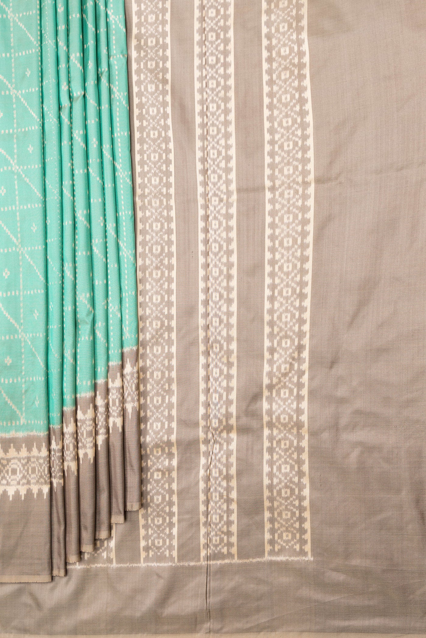 Pleats and pallu of Sea Green Dual Tone Double Ikat Saree with Ikat Print on the body and Ikat Border. 
