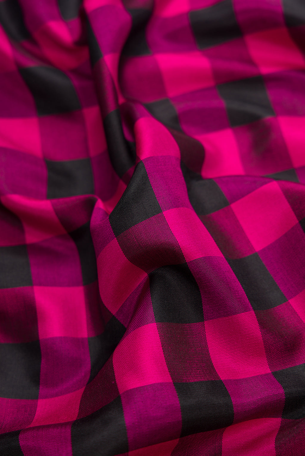 Close up of Black and Pink Color Gadwal Silk Saree with Checked design on the body and Temple Border.  displaying folds