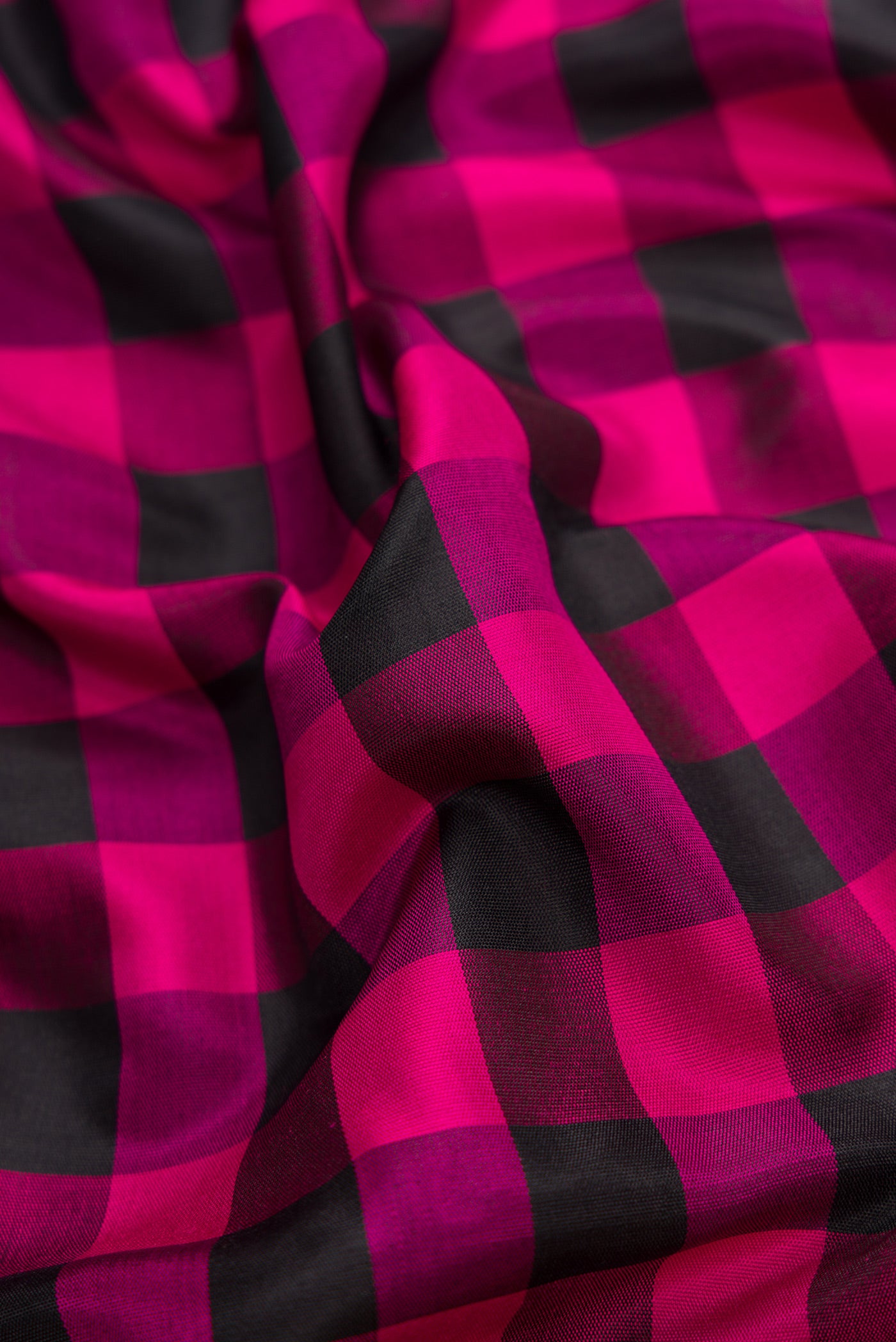 Close up of Black and Pink Color Gadwal Silk Saree with Checked design on the body and Temple Border.  displaying folds