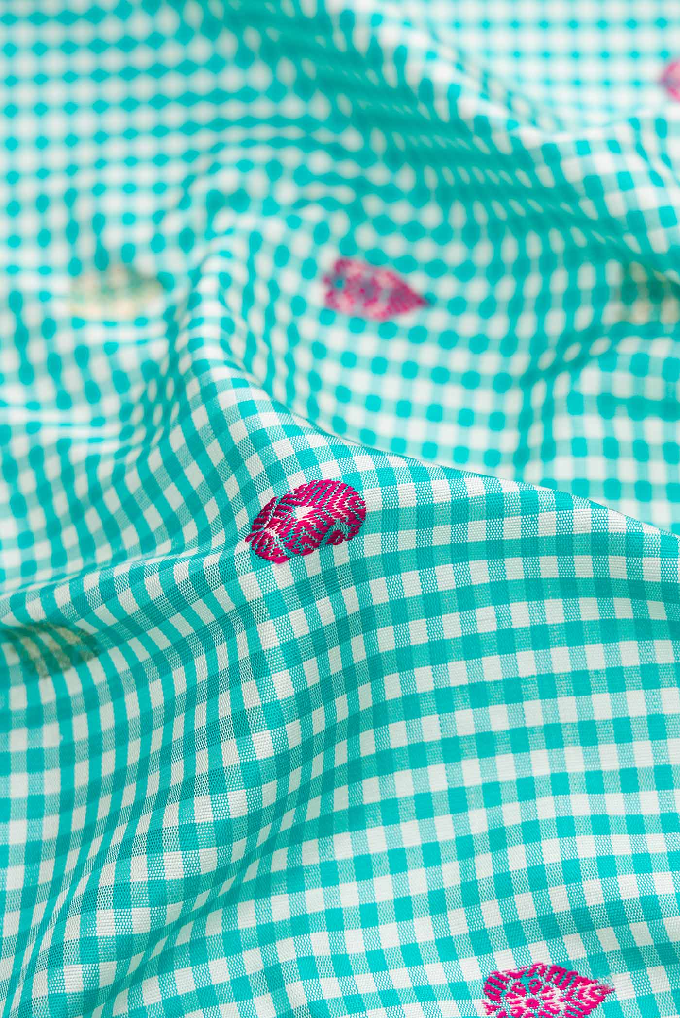 Close up of Light Blue Gadwal Silk Saree with Checked design on the body and Zari Border displaying folds