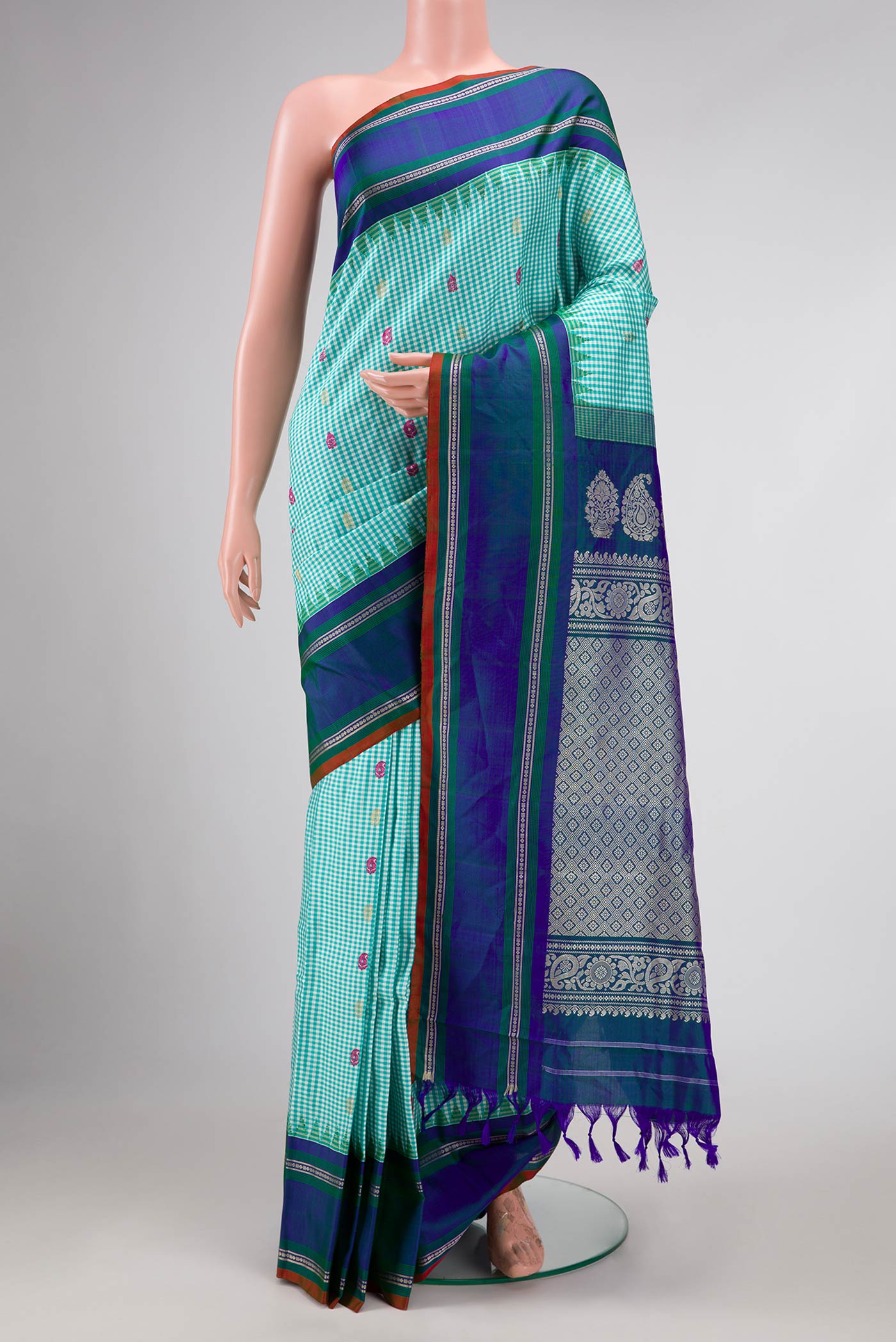 Light Blue Gadwal Silk Saree with Checked design on the body and Zari Border displayed on a mannequin