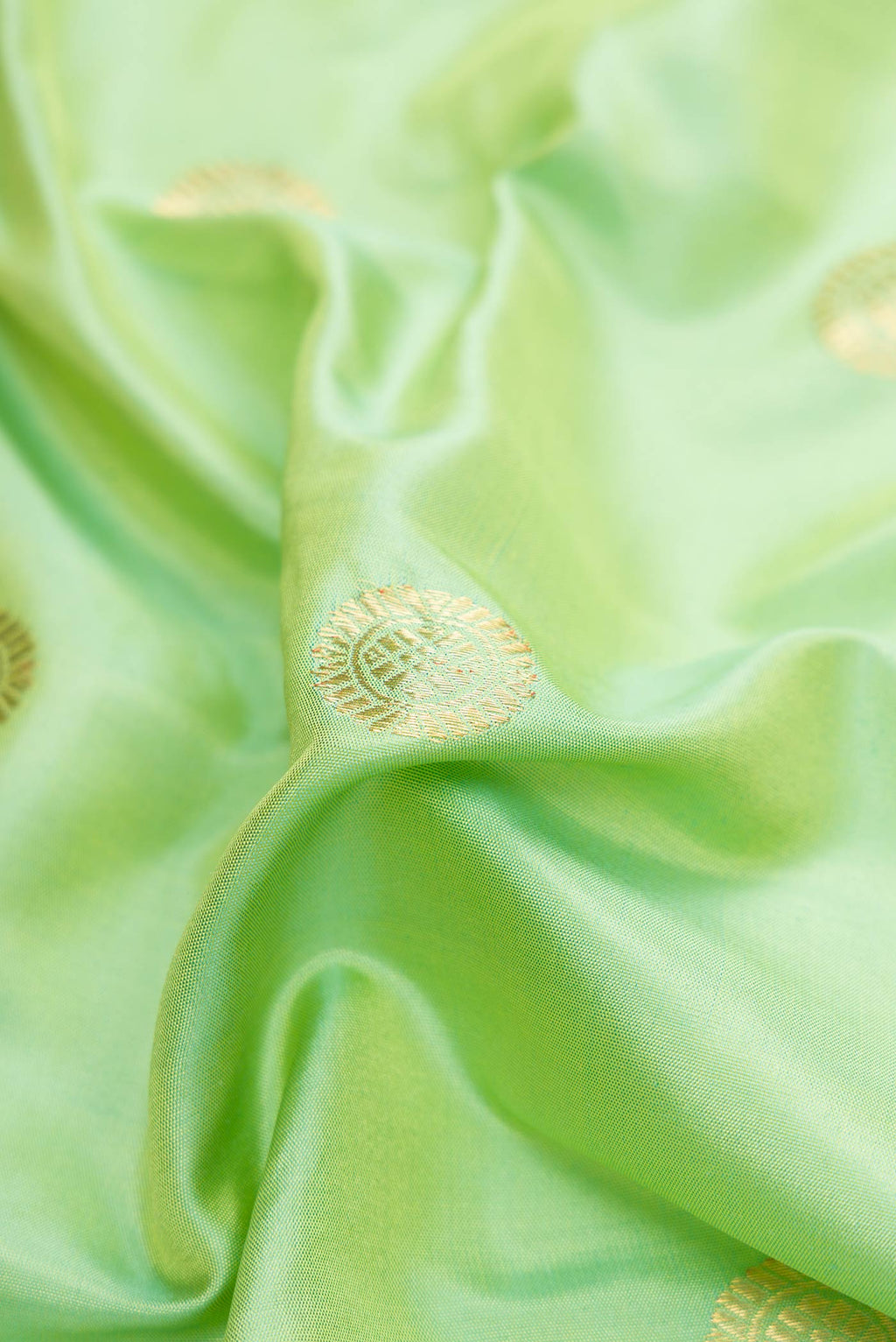 Close up of Pista Green Dual Tone Gadwal Silk Saree with Zari Butta on the body and Zari Border displaying folds