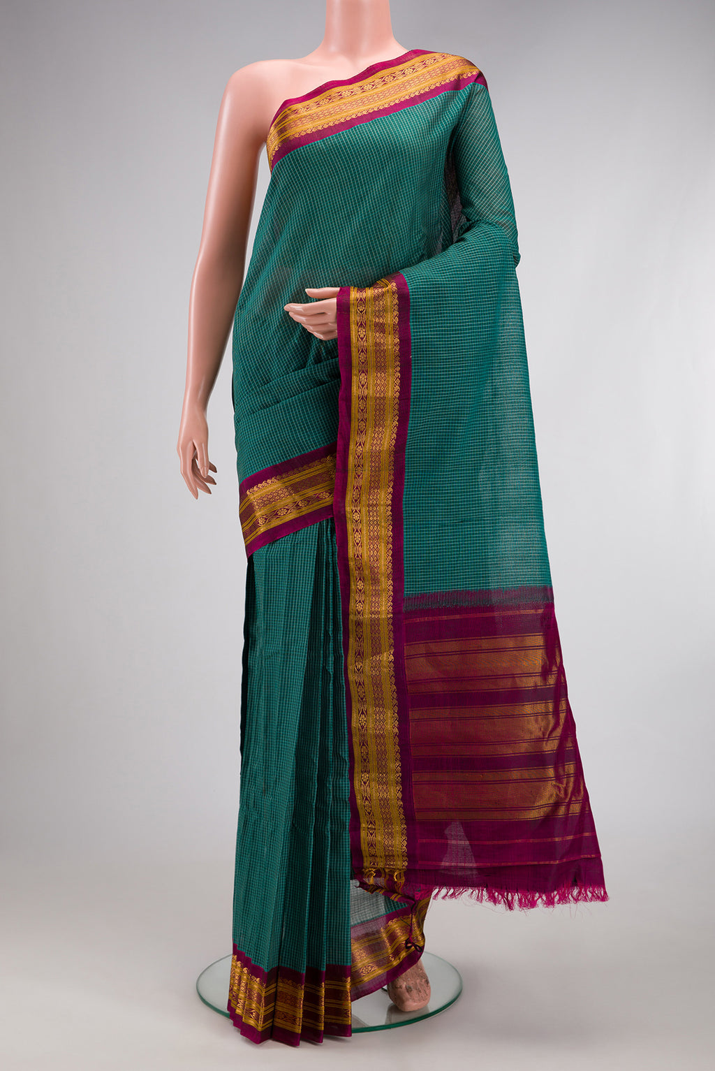 Green Gadwal cotton Saree with Checked design on the body and Silk Border.  displayed on a mannequin