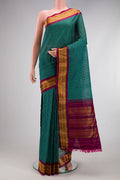 Green Gadwal cotton Saree with Checked design on the body and Silk Border.  displayed on a mannequin