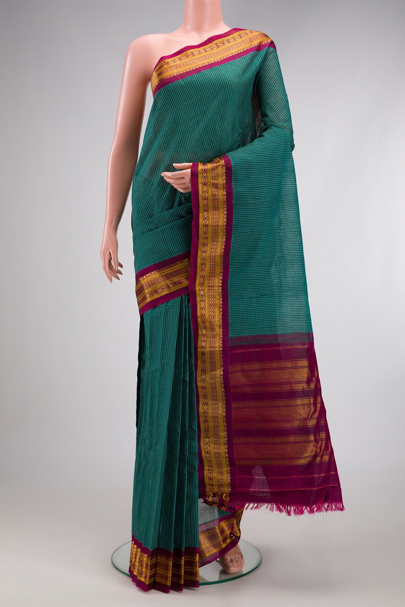 Green Gadwal cotton Saree with Checked design on the body and Silk Border.  displayed on a mannequin
