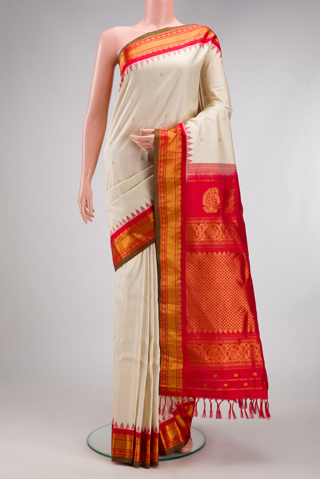 Off White Gadwal Silk Saree with Zari Butta on the body and Zari Border.  displayed on a mannequin