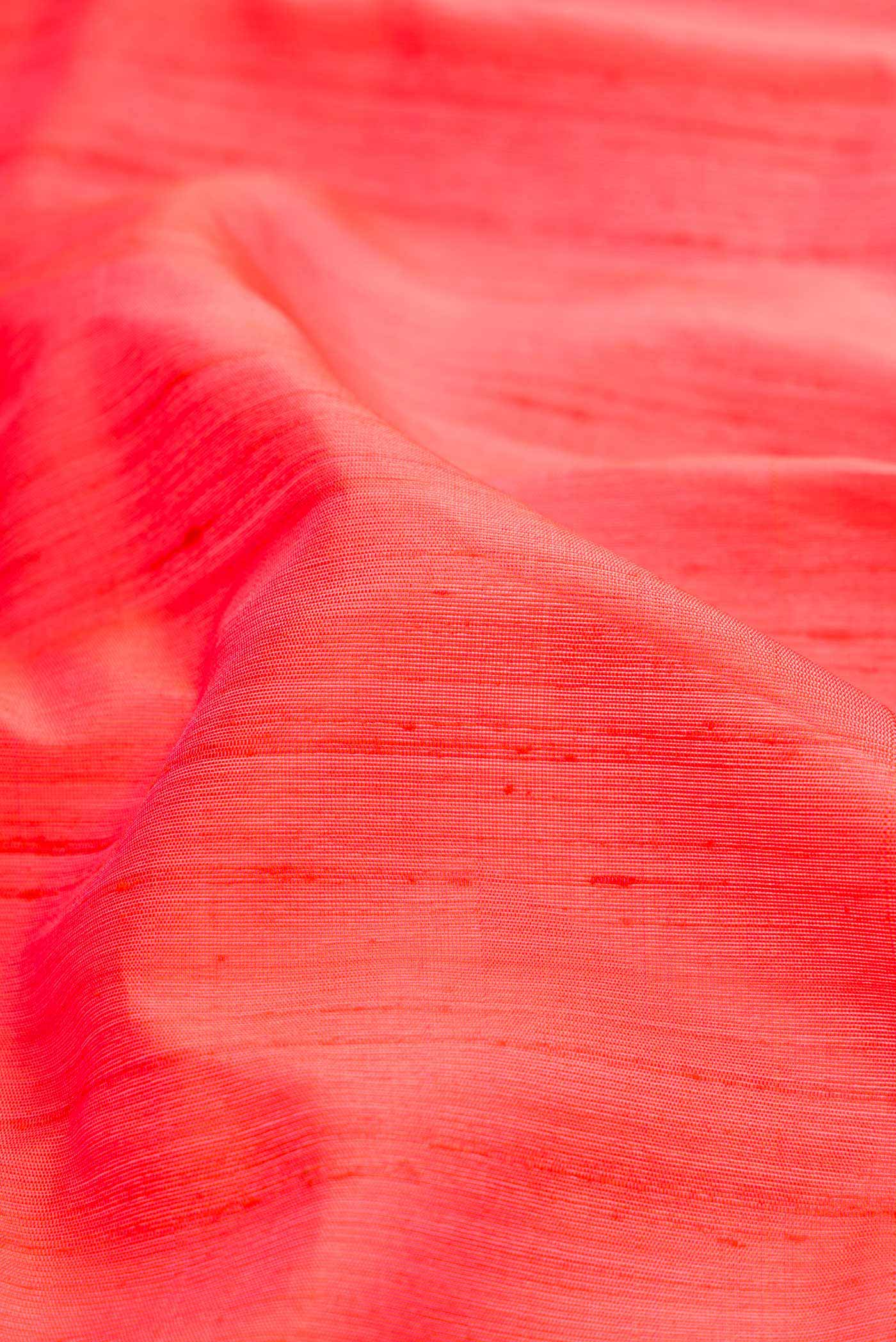 Close up of Orange Dual Tone Gadwal Silk Saree with Plain Body and Fancy Border displaying folds