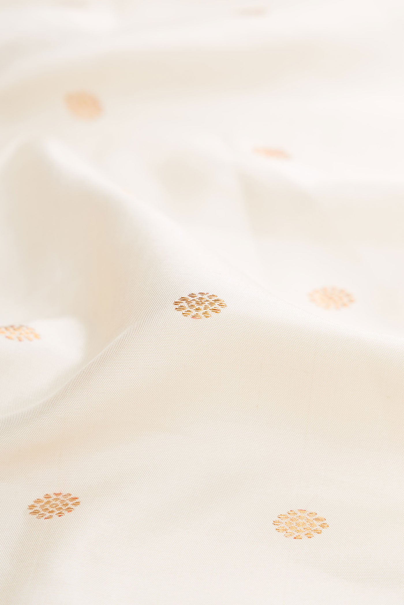 Close up of Off White Dual Tone Gadwal Silk Saree with Zari Butta on the body and Zari Border displaying folds