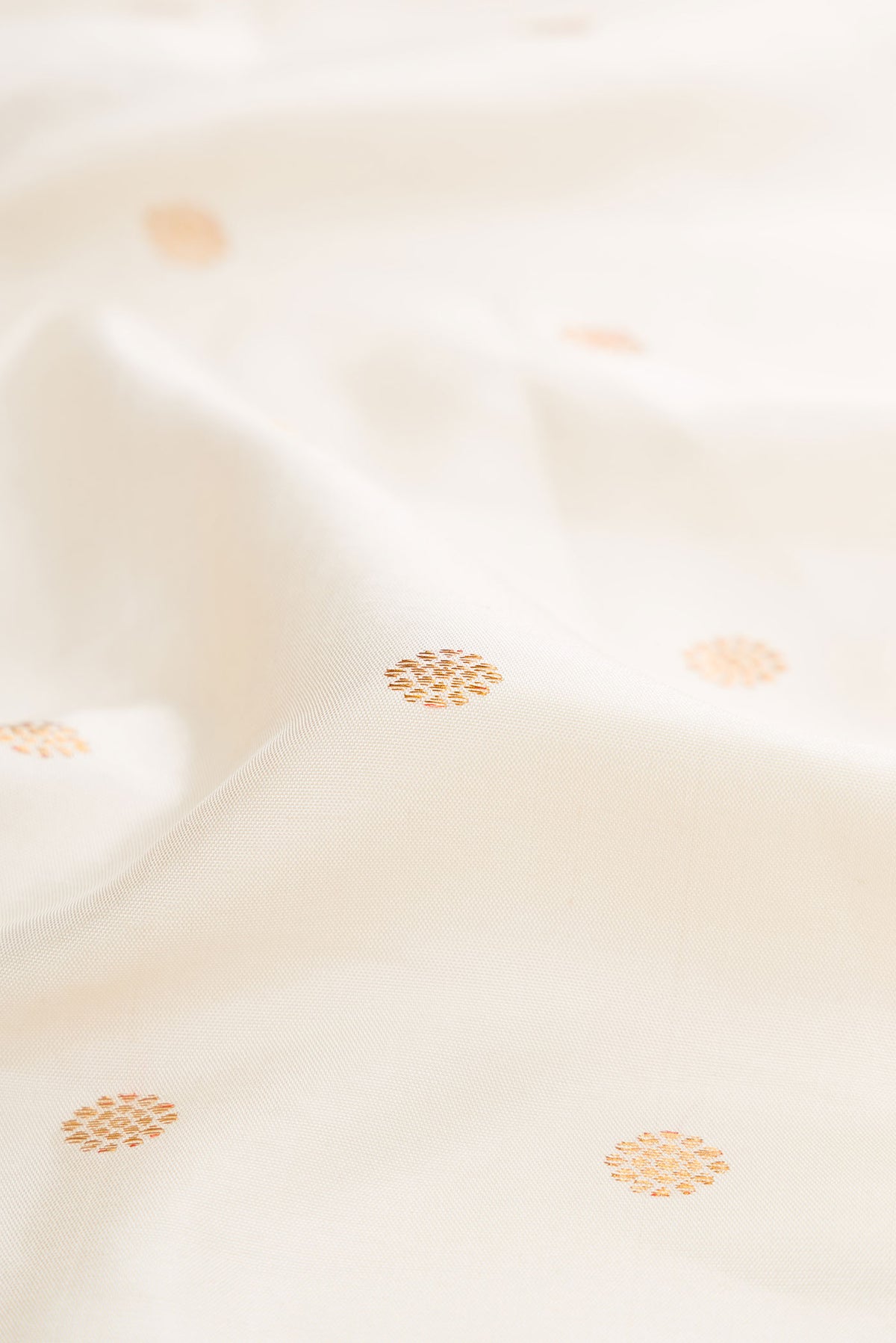 Close up of Off White Dual Tone Gadwal Silk Saree with Zari Butta on the body and Zari Border displaying folds