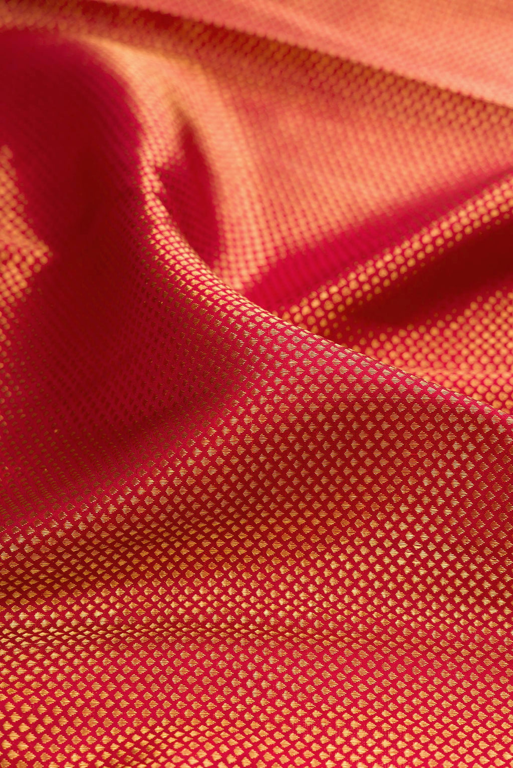 Close up of Maroon Kanchipuram Silk Saree with Zari Brocade on the body and Zari Border.  displaying folds