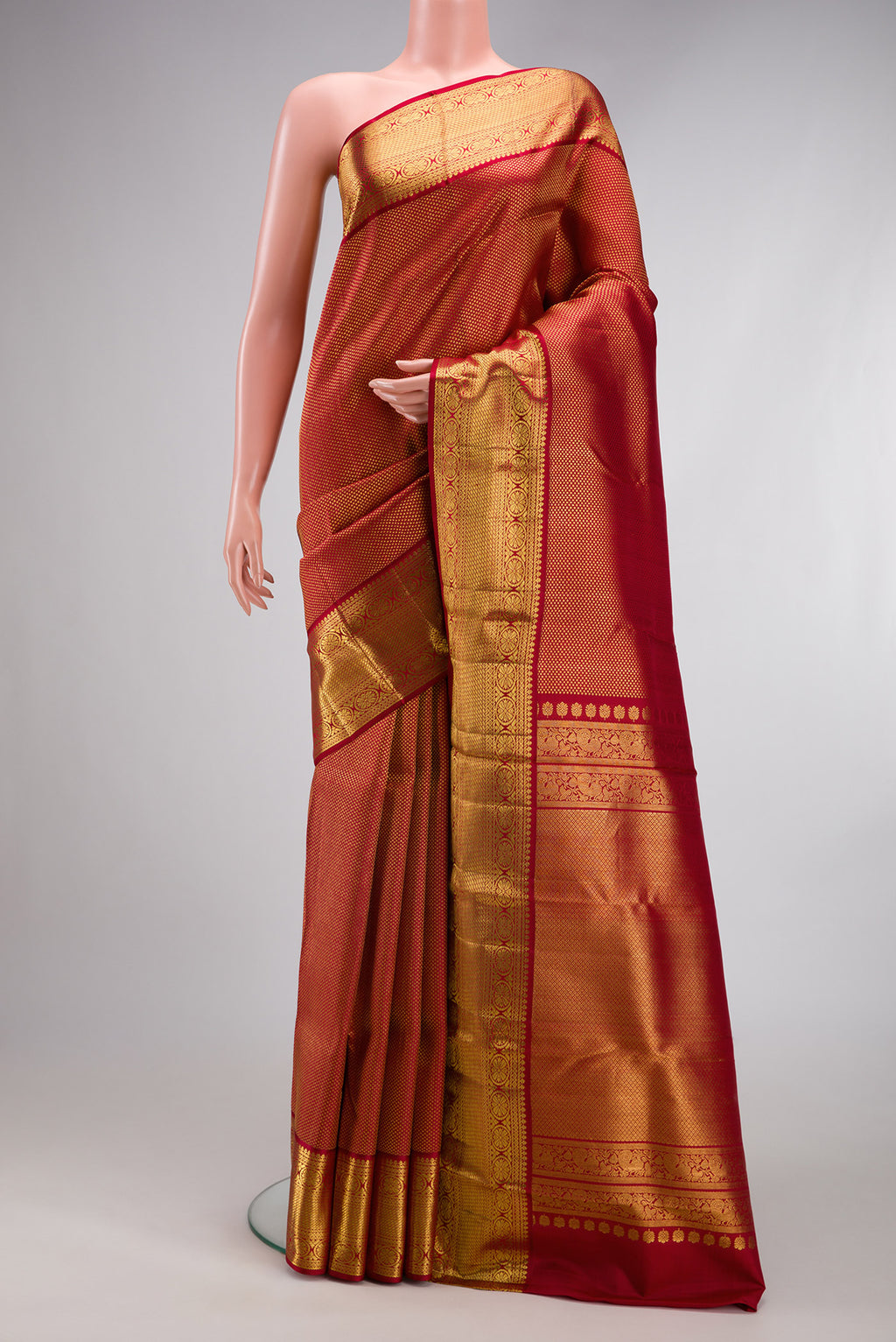 Maroon Kanchipuram Silk Saree with Zari Brocade on the body and Zari Border.  displayed on a mannequin