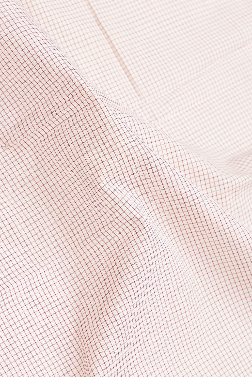 Close up of Off White Dual Tone Double Ikat Saree with Checked design on the body and Ganga Jamuna Border.  displaying folds