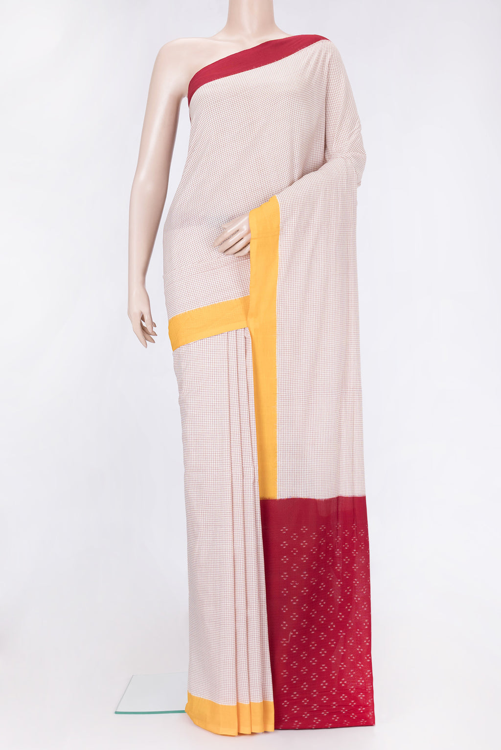 Off White Dual Tone Double Ikat Saree with Checked design on the body and Ganga Jamuna Border.  displayed on a mannequin