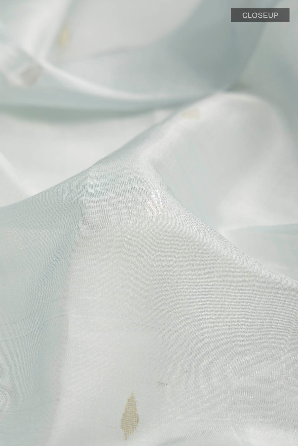 Close up of Light Blue Bhagalpuri Tussar Silk Saree with Zari Butta on the body and Zari Border displaying folds