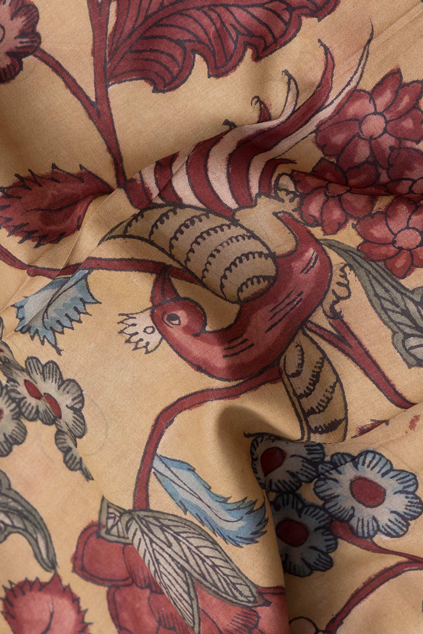 Close up of Dark Beige Dual Tone Tussar Silk Saree with kalamkari Print on the body and Zari Border.  displaying folds