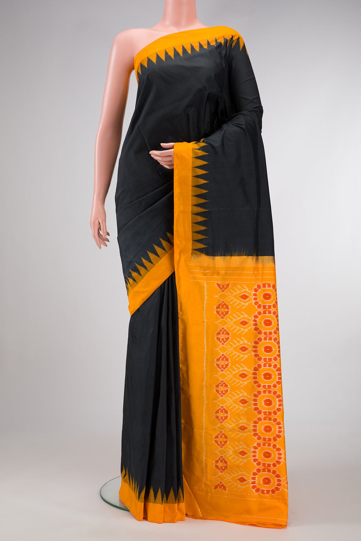 Black Dual Tone Double Ikat Saree with Plain Body and Temple Border.  displayed on a mannequin
