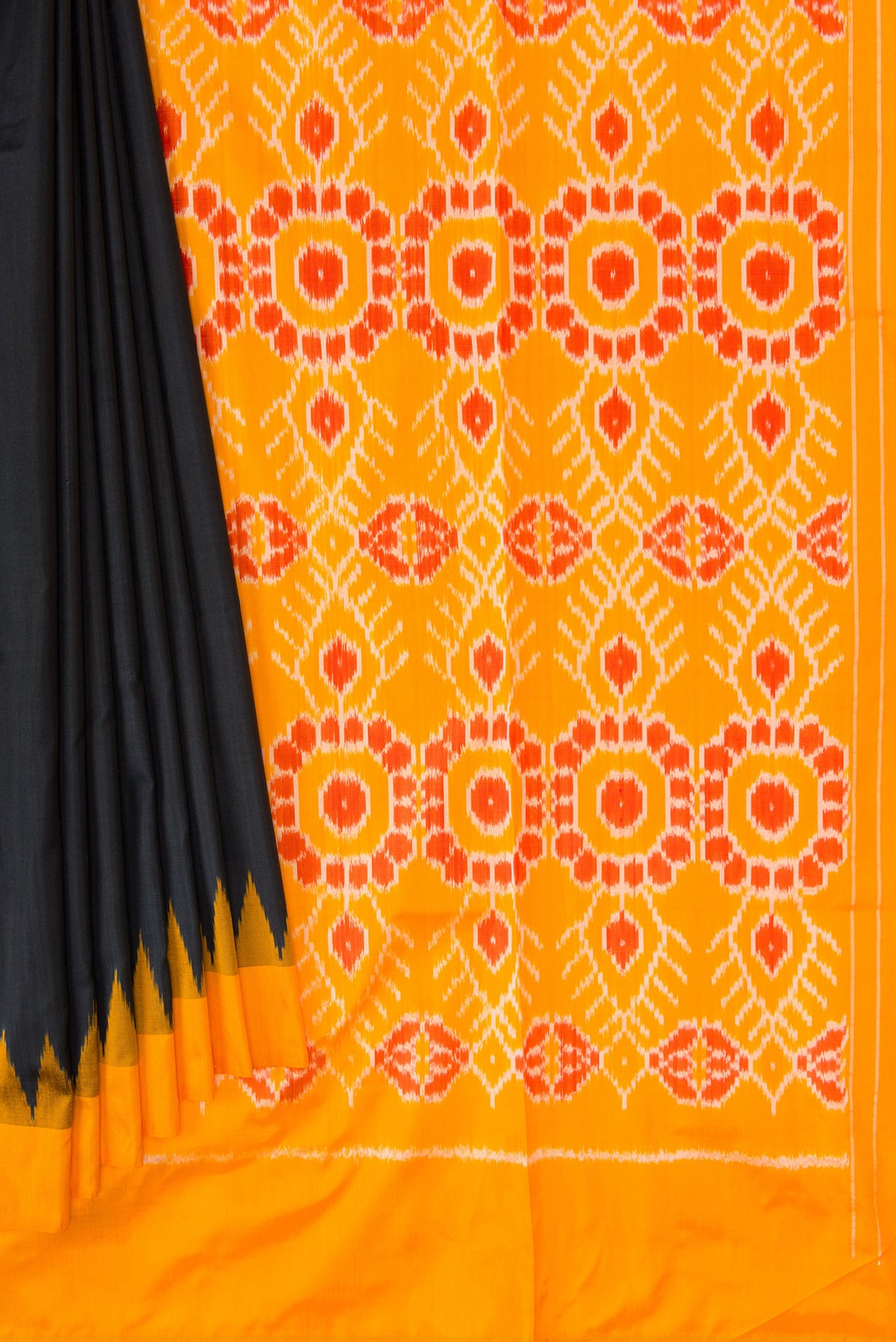 Pleats and pallu of Black Dual Tone Double Ikat Saree with Plain Body and Temple Border. 