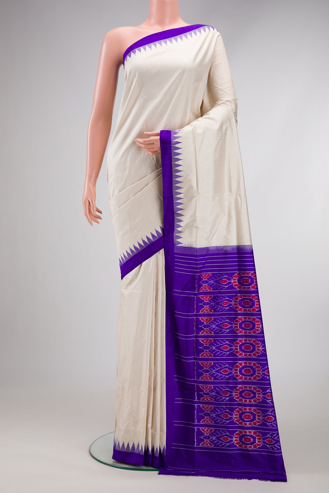Off White Double Ikat Saree with Plain Body and Ikat Border.  displayed on a mannequin