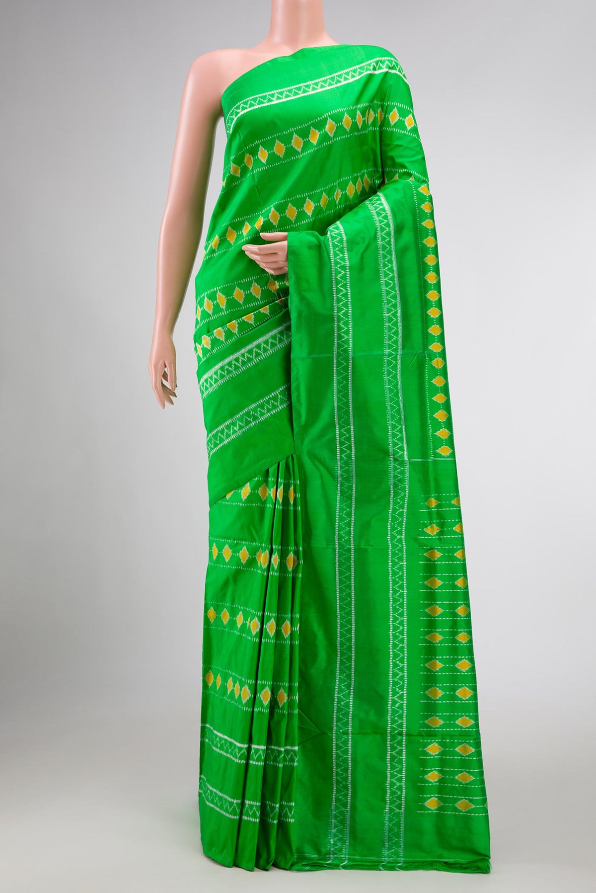 Parrot Green Dual Tone Rajkot Patola Silk Saree with Ikat Print on the body and Ikat Border displayed on a mannequin