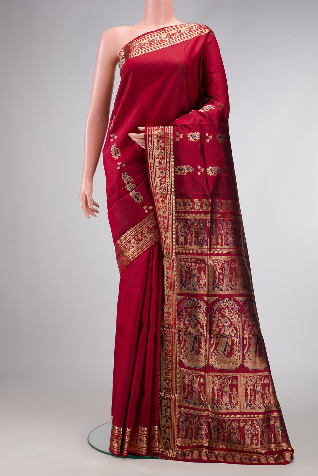 Maroon Dual Tone Baluchari Silk Saree with Zari And Thread Butta on the body and Fancy Border.  displayed on a mannequin