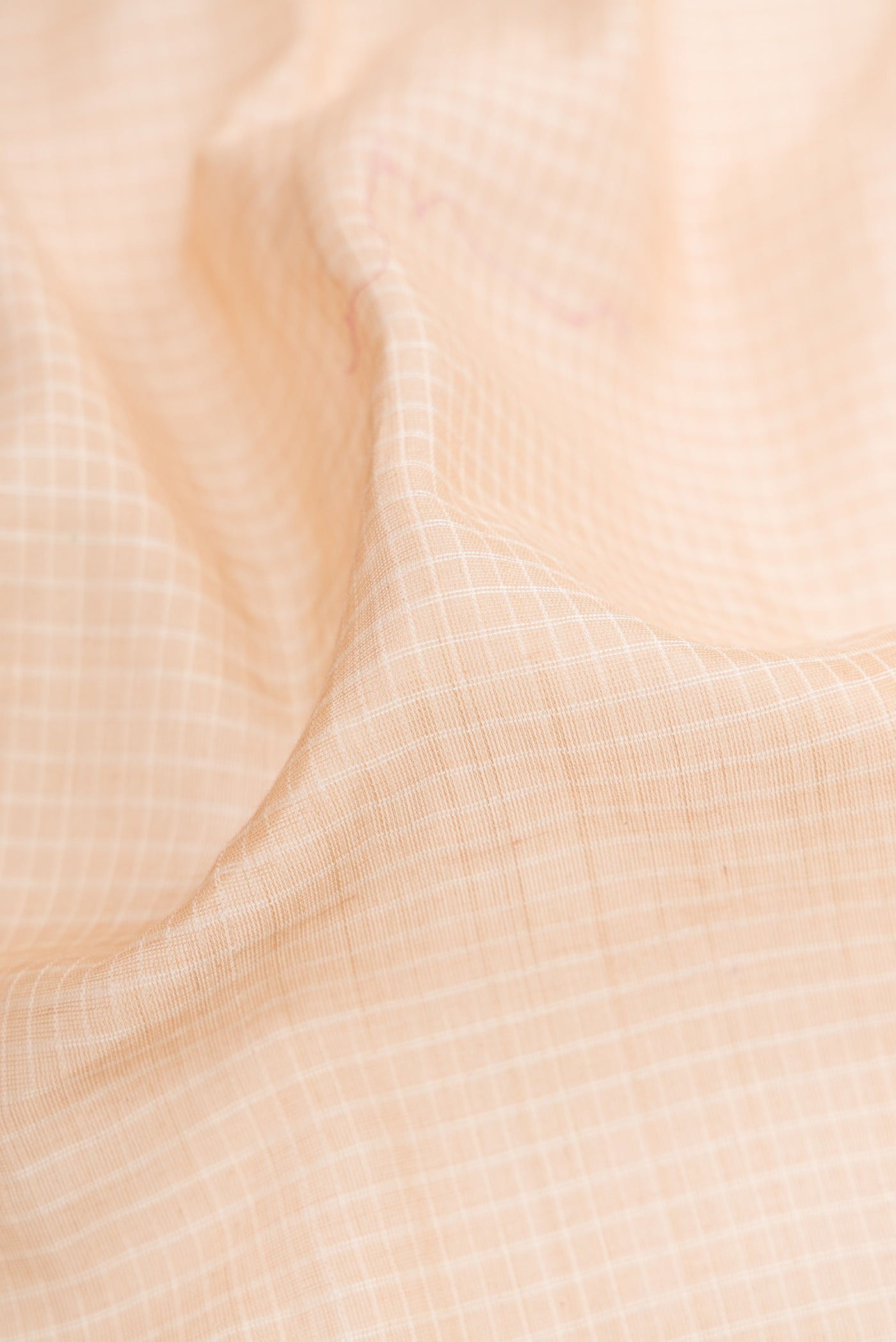 Close up of Beige Gadwal cotton Saree with Checked design on the body and Silk Border.  displaying folds