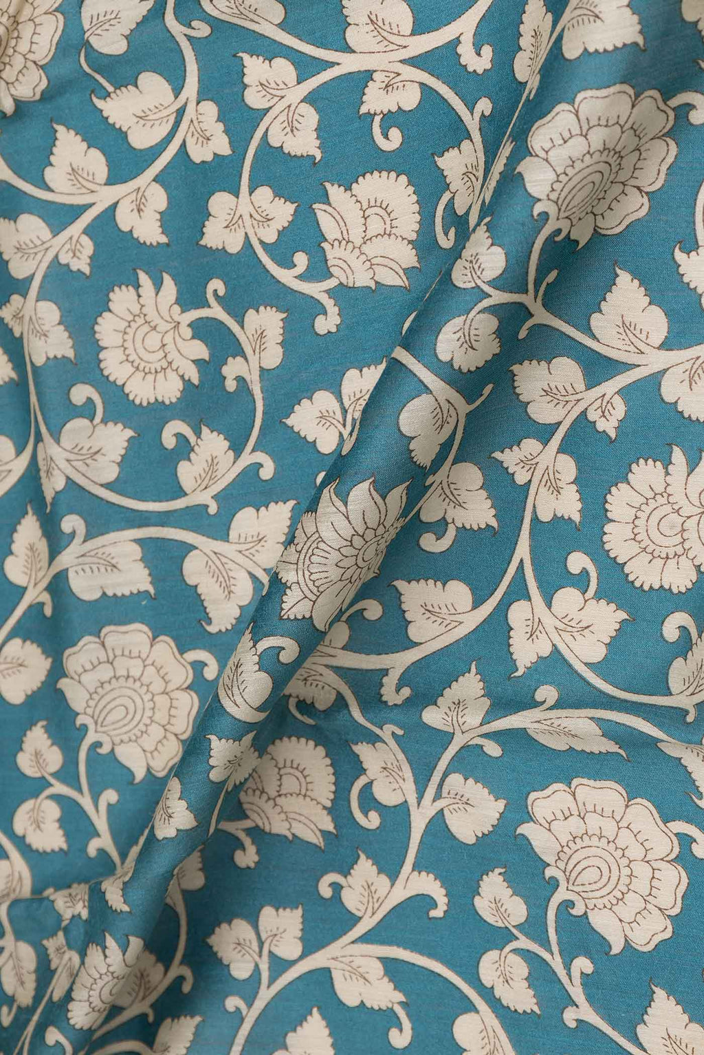 Close up of Blue Dual Tone Tussar Saree with Printed design on the body and Zari Border displaying folds