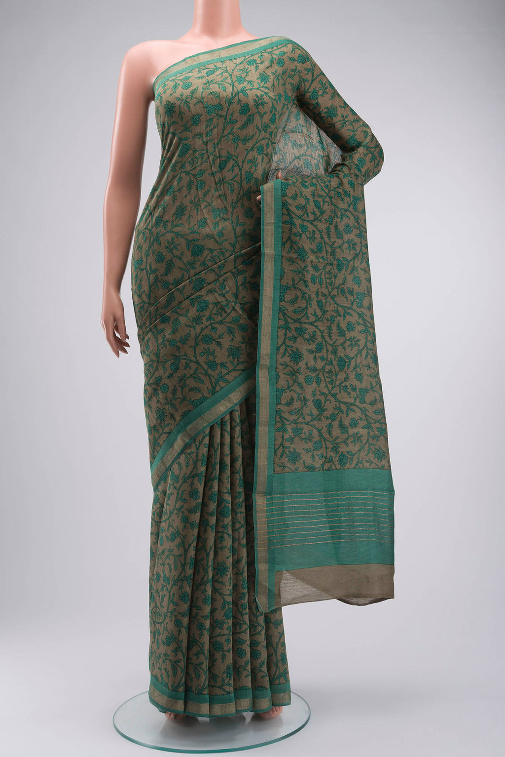 Green Tussar Silk Saree with Printed design on the body and Zari Border displayed on a mannequin