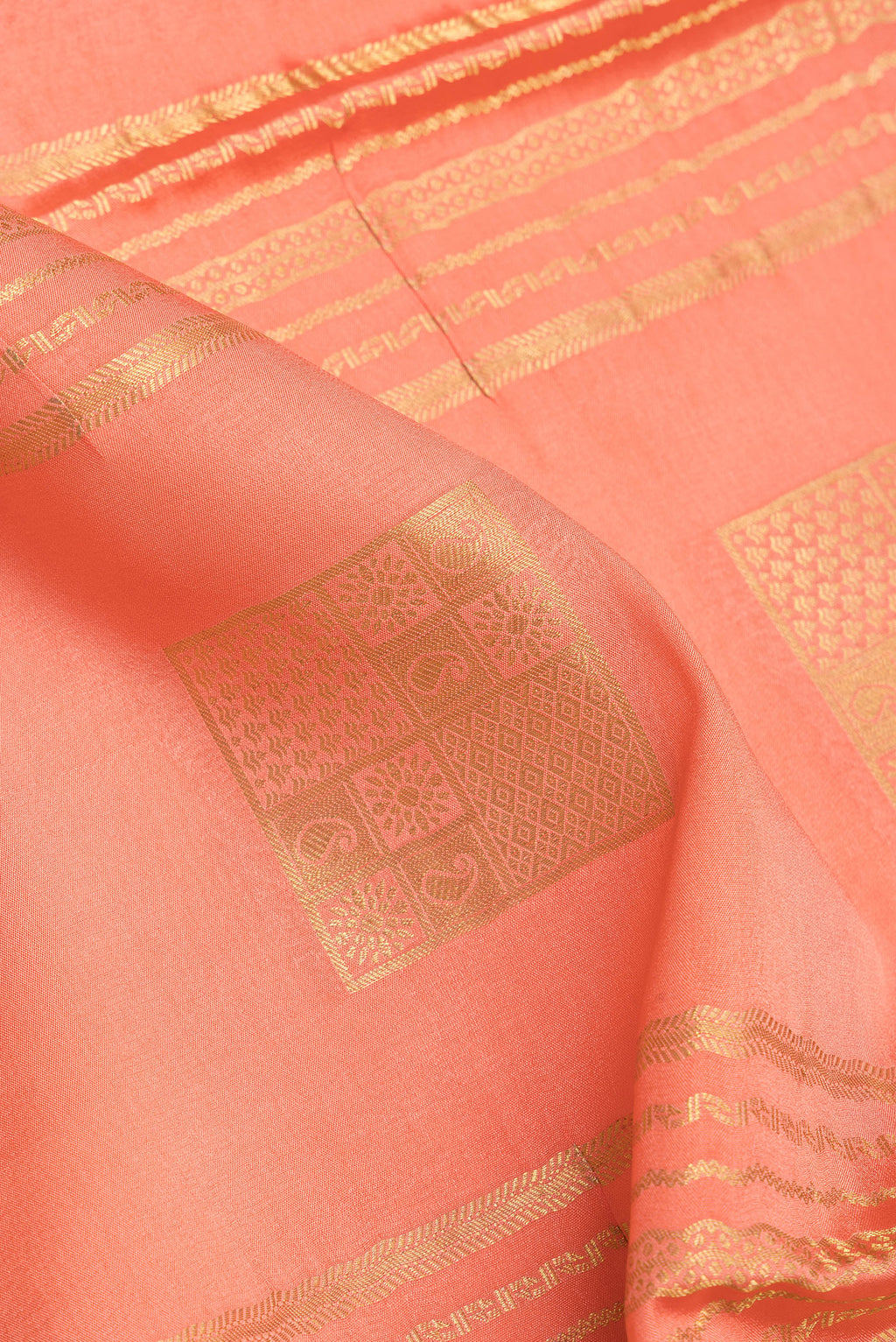 Close up of Peach Mysore Silk Saree with Checked design on the body and Zari Border.  displaying folds