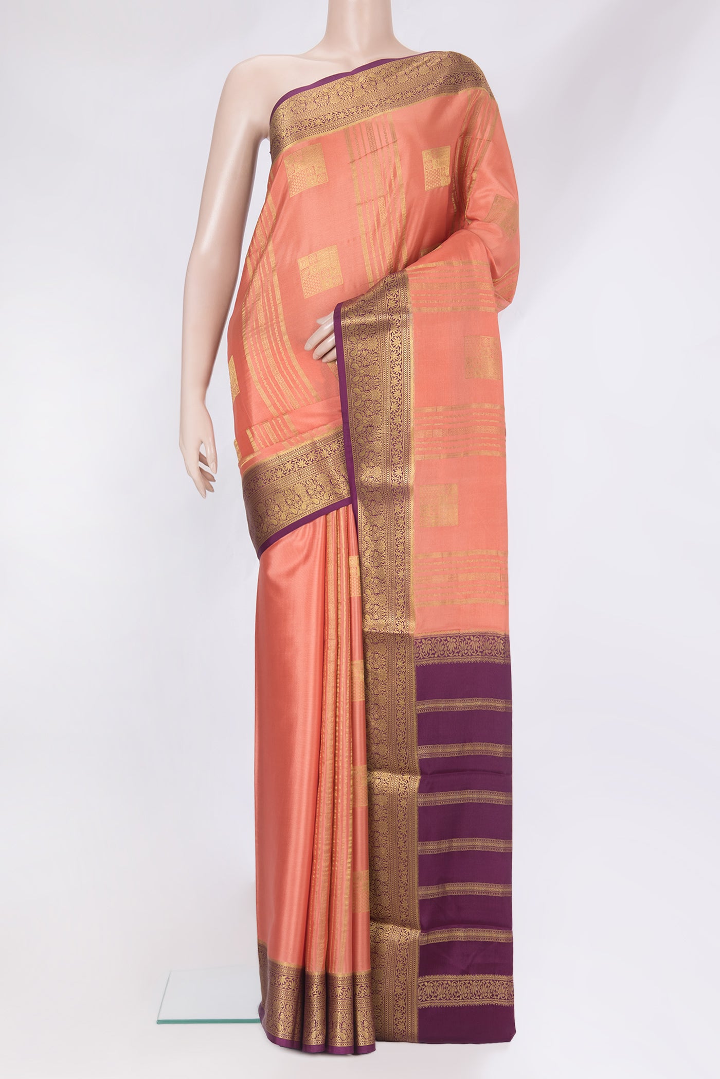 Peach Mysore Silk Saree with Checked design on the body and Zari Border.  displayed on a mannequin