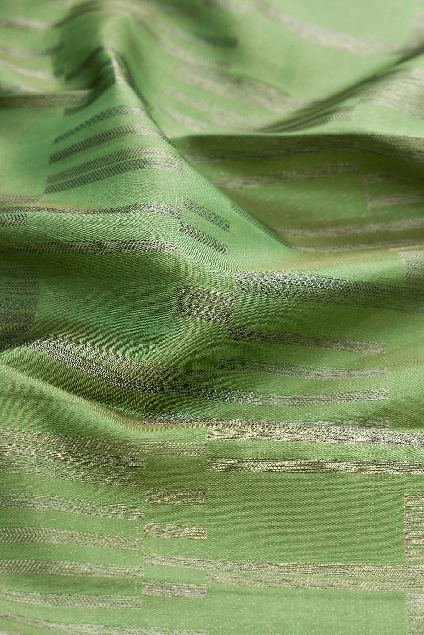 Close up of Green Dual Tone Kanchipuram Silk Saree with Zari Brocade on the body and Zari Border displaying folds