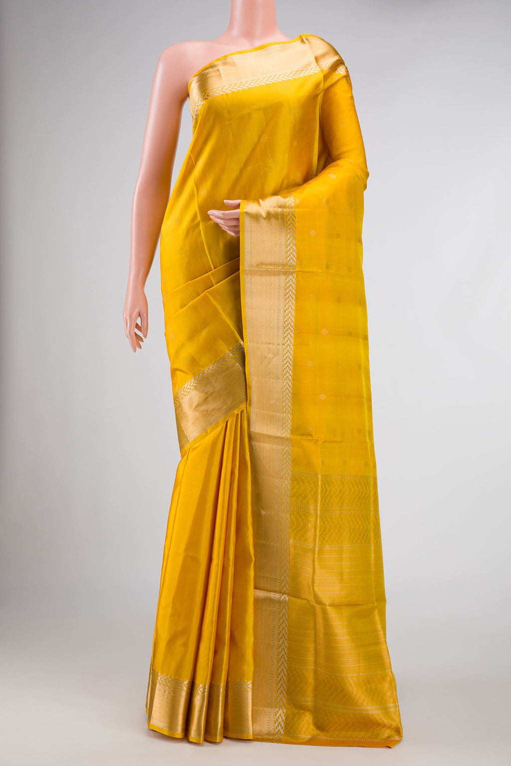 Mustard Dual Tone Soft Silk Saree with Zari Butta on the body and Zari Border.  displayed on a mannequin