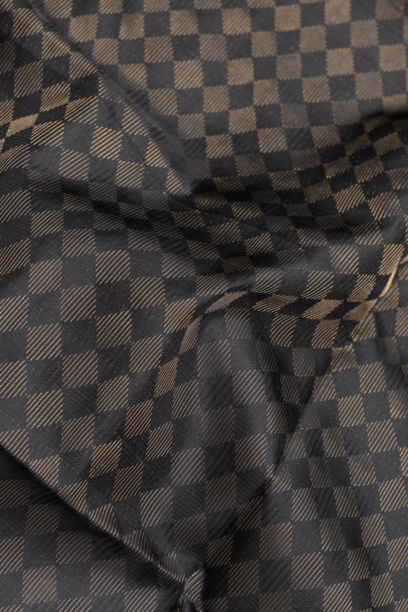 Close up of Black Dual Tone Soft Silk Saree with Zari Brocade on the body and Zari Border.  displaying folds